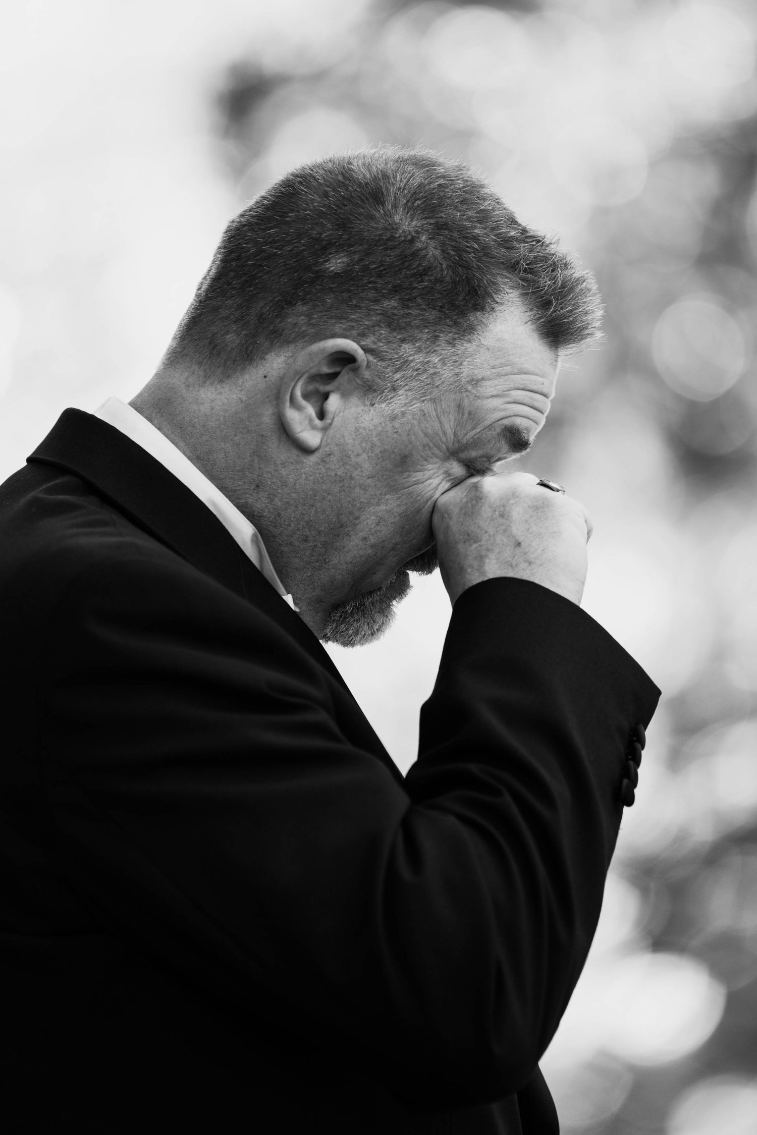 Black and white emotional moments captured during wedding ceremony.