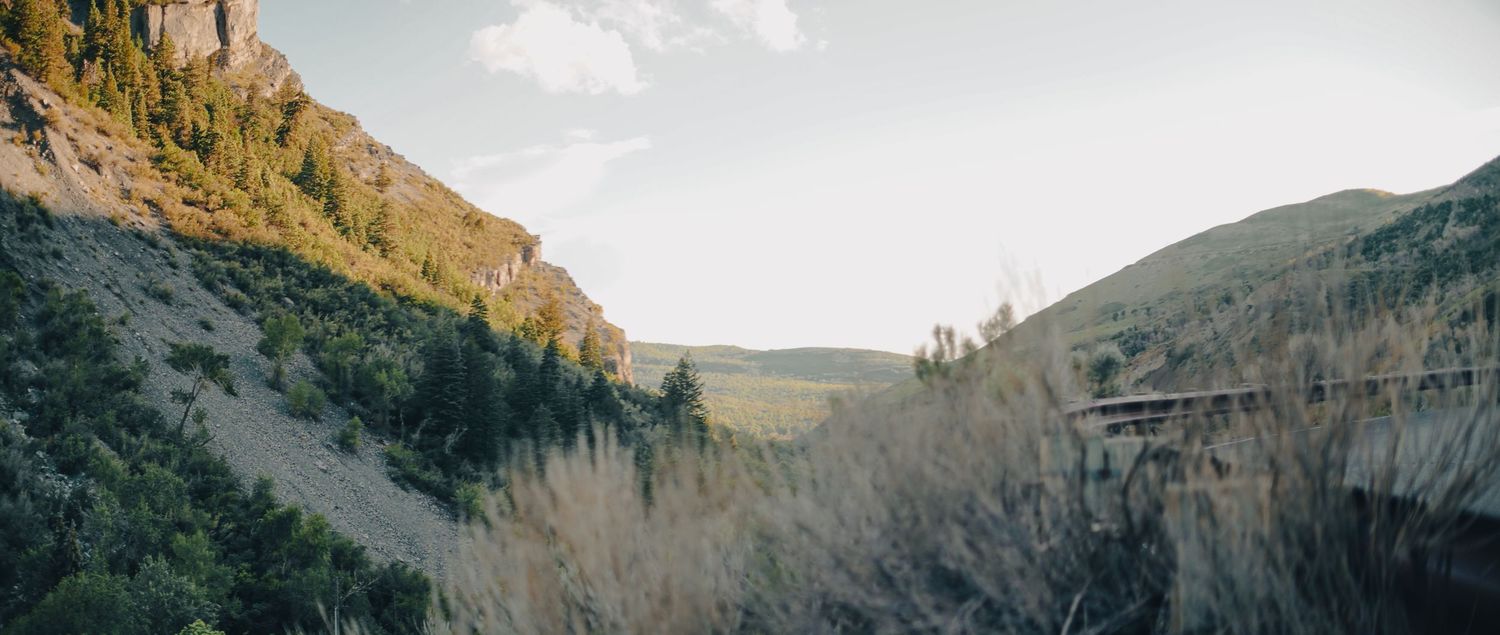 Dramatic mountain landscape with rugged peaks and valleys stretching into the distance.