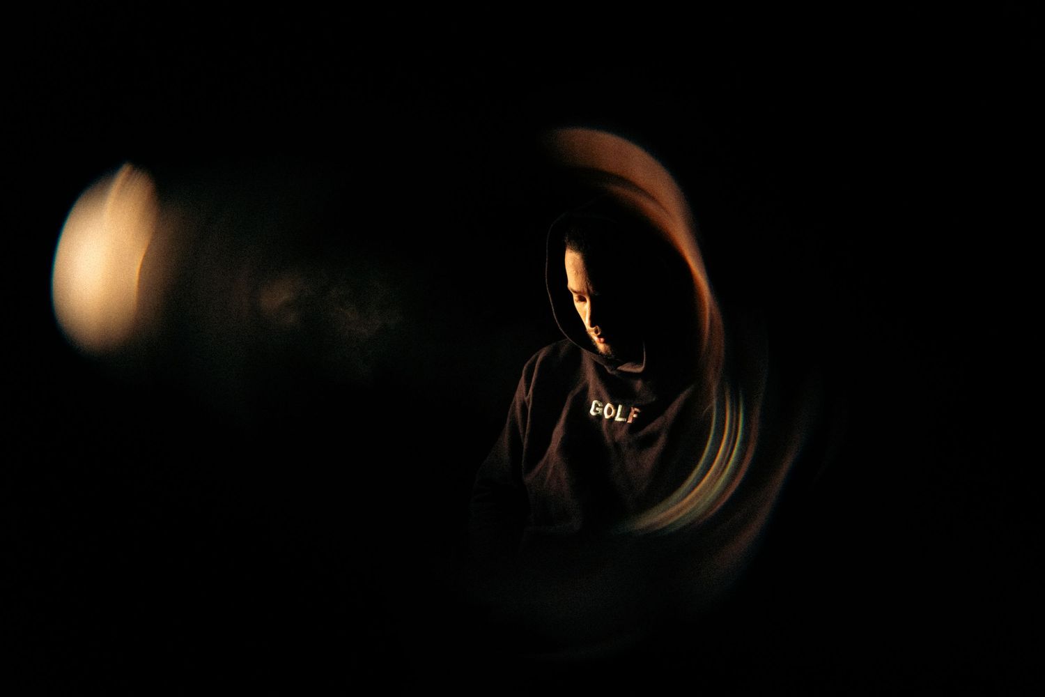 Abstract black and white composition with circular light patterns in darkness.
