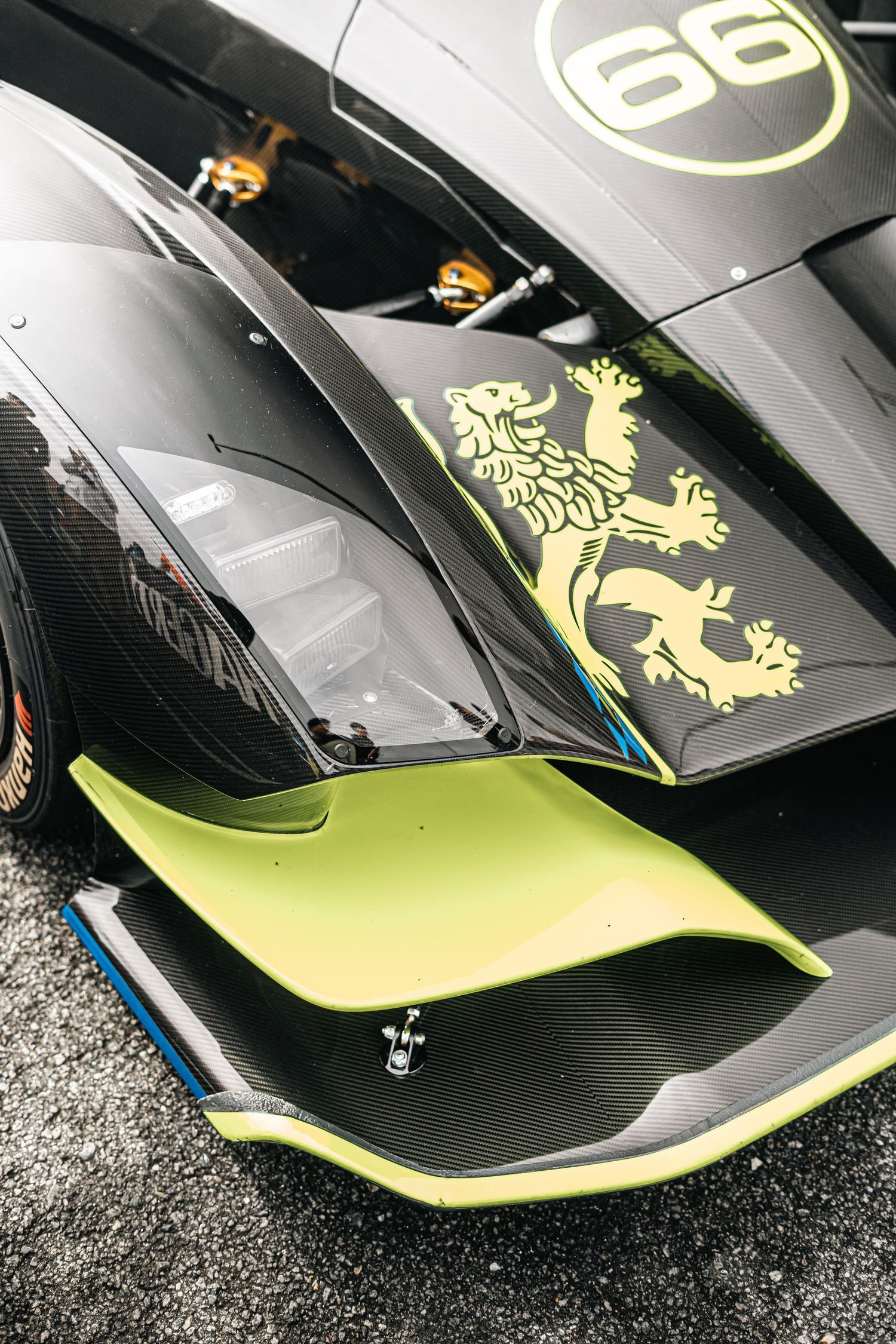 Black and neon yellow sports car bodywork with decorative graphics and emblems.