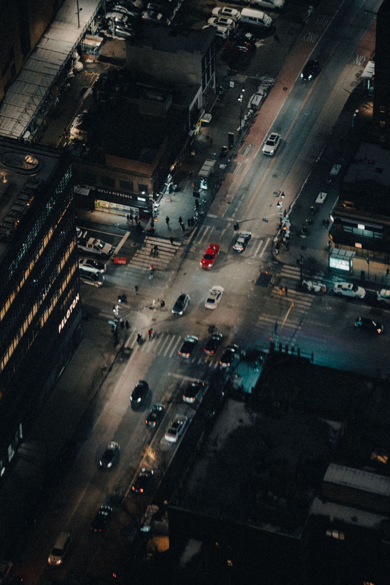 Aerial view of city streets at night showing traffic patterns and illuminated intersections.