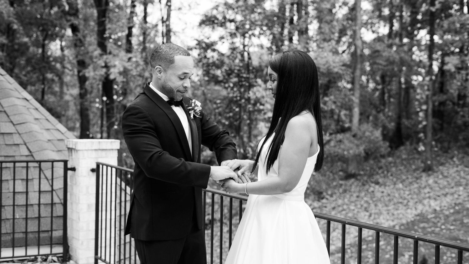 Outdoor wedding ceremony setup with iron gates and natural greenery.