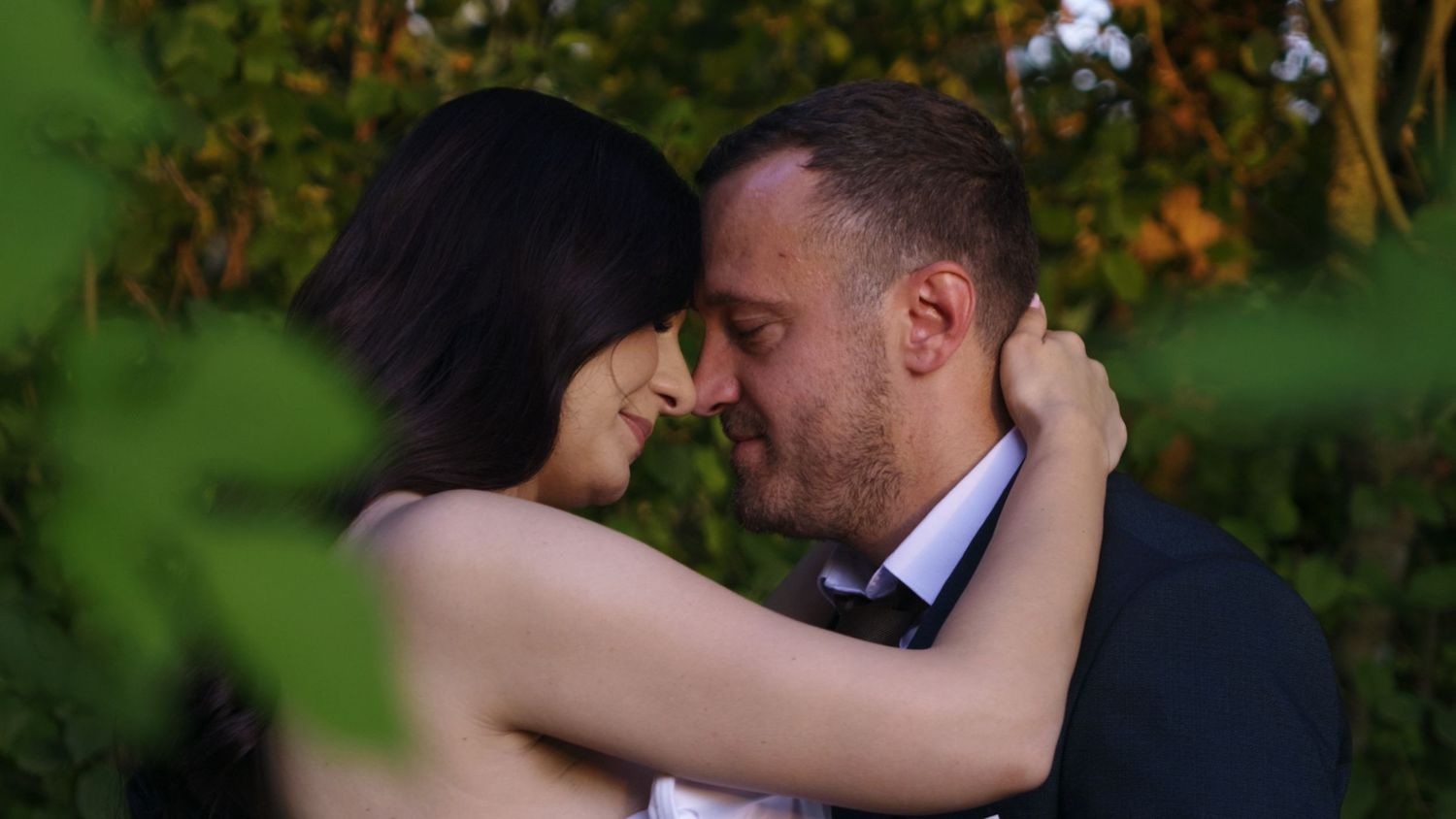 Romantic garden scene with soft bokeh effect through green foliage.
