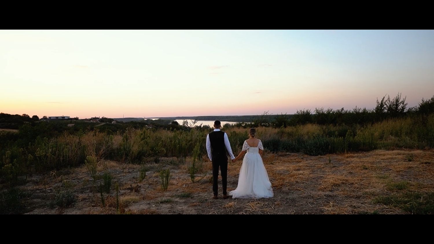 Sunset wedding photography session in an open field.