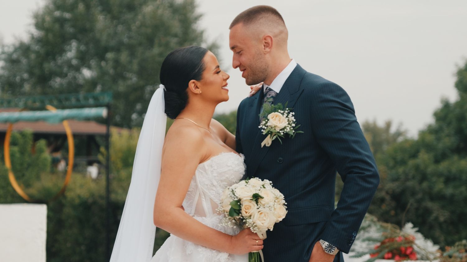 Bride and groom share an intimate moment outdoors during their wedding day.