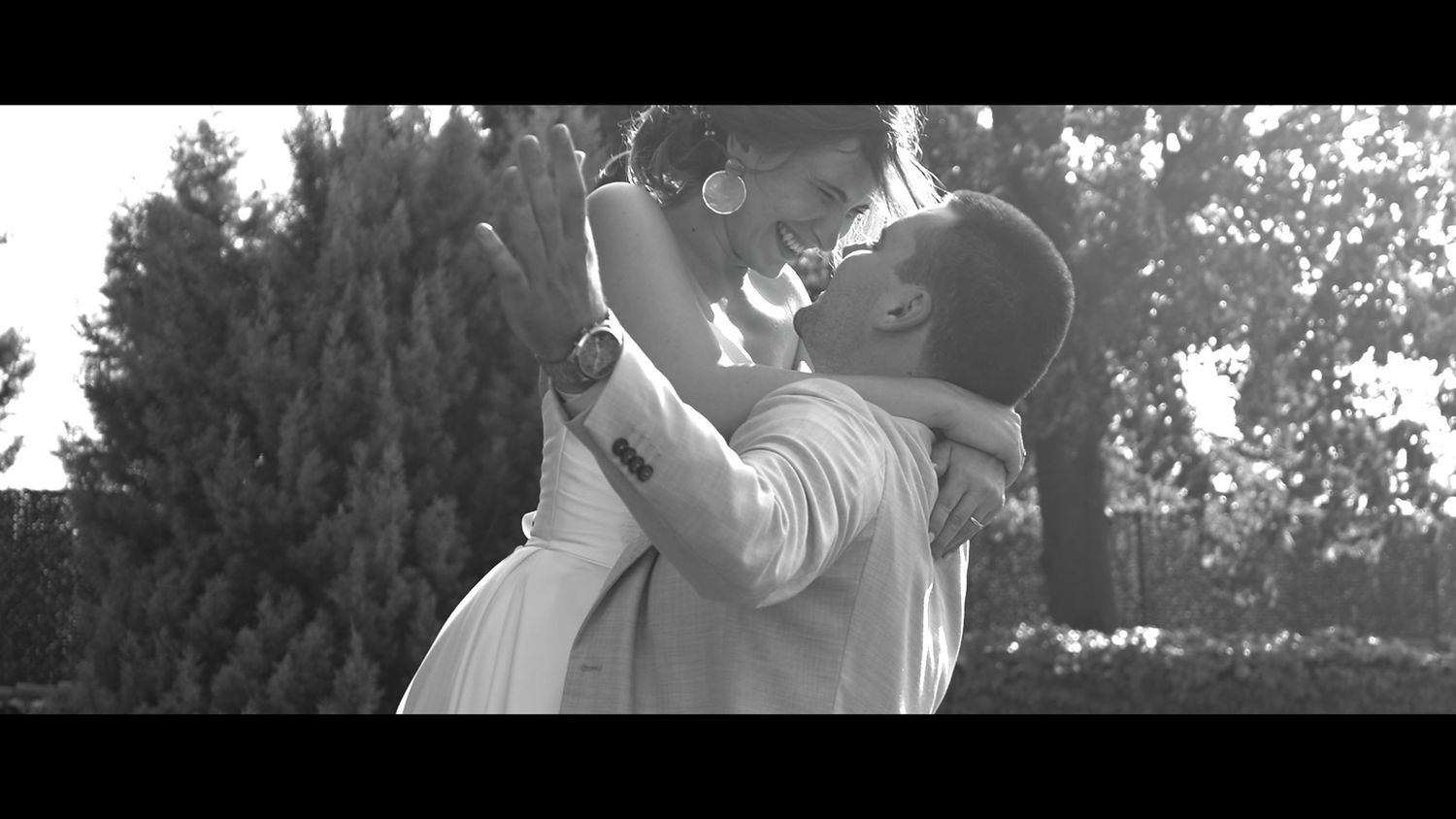 A joyful black and white moment captured during an outdoor celebration.