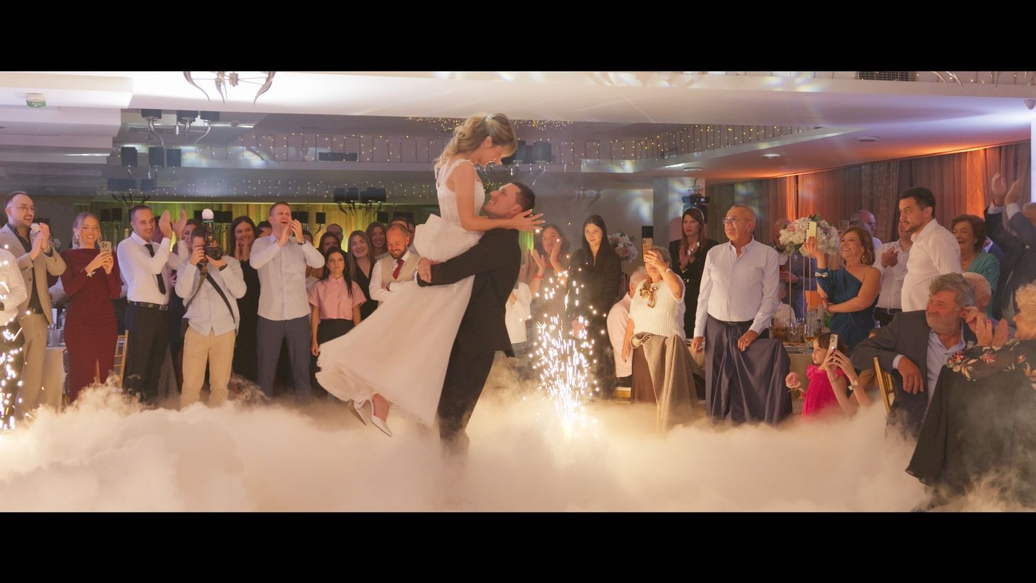 Wedding reception dance floor filled with guests celebrating.