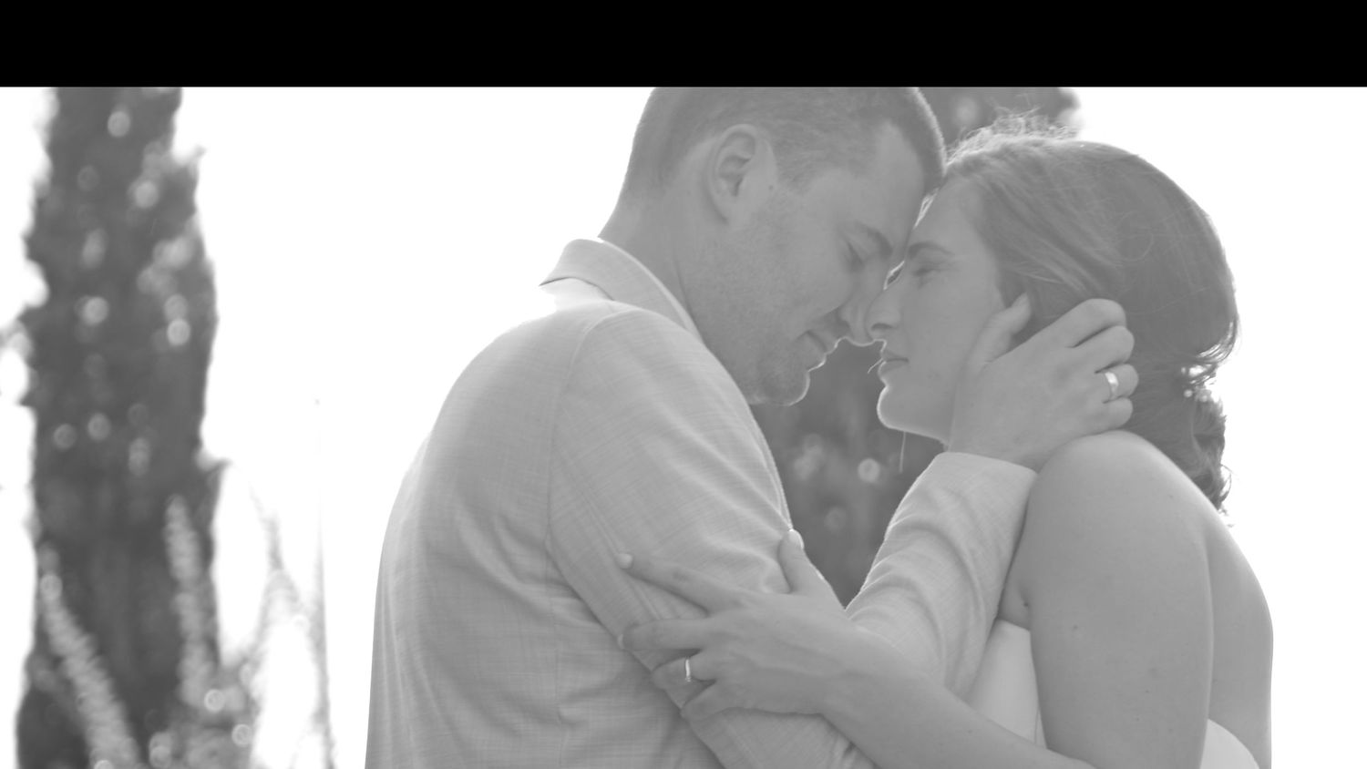 Romantic outdoor wedding moment captured in black and white photography.