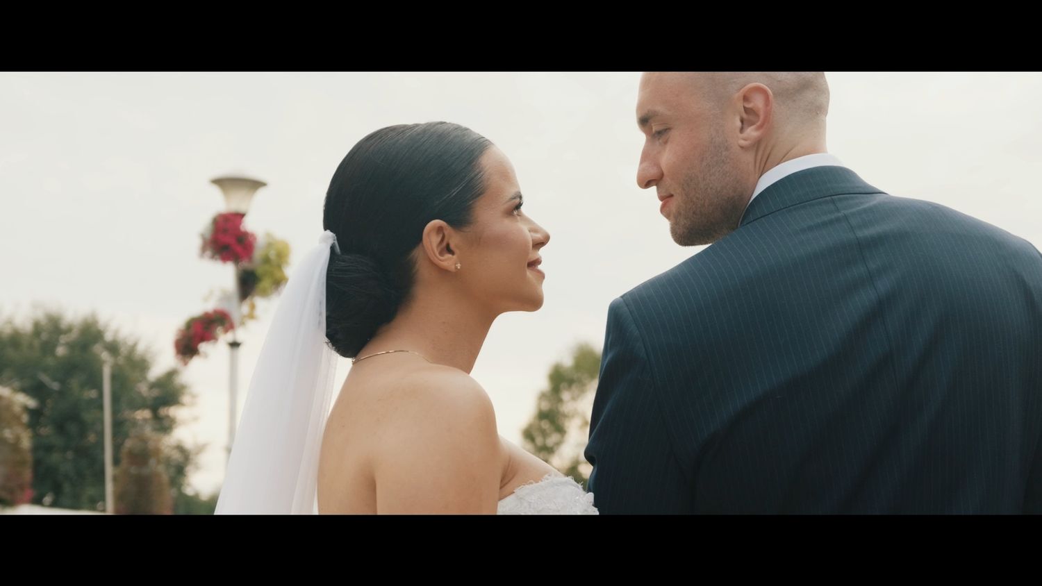 Couple shares intimate moment during outdoor wedding photoshoot.