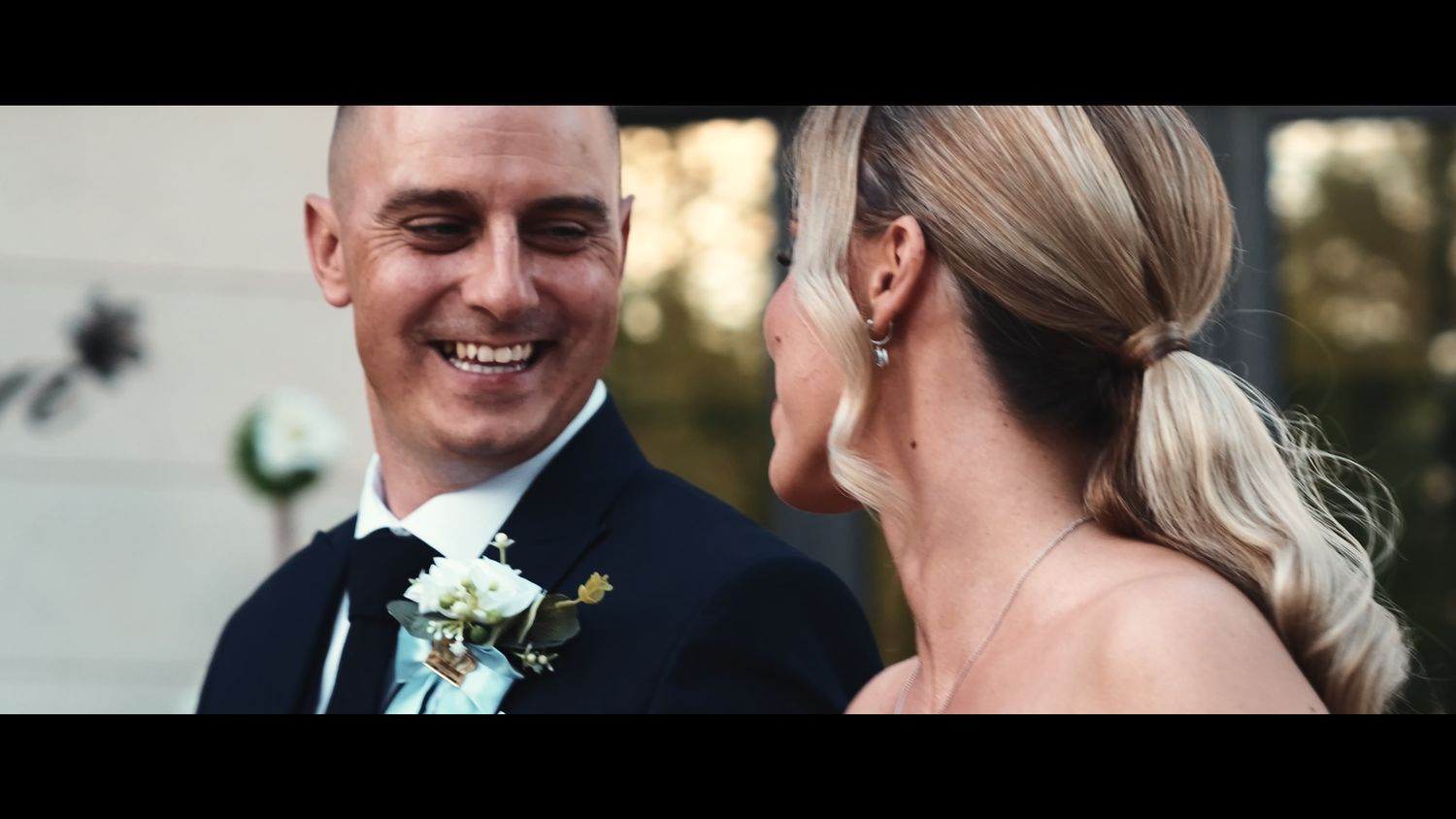 Joyful wedding couple sharing intimate moments during outdoor photo session.