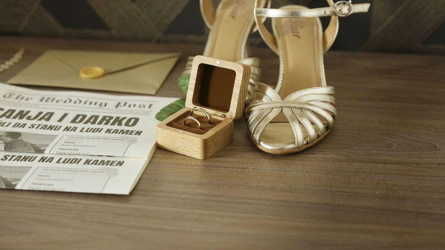 Wedding reception table details with place cards and decor arranged on a rustic wooden surface.