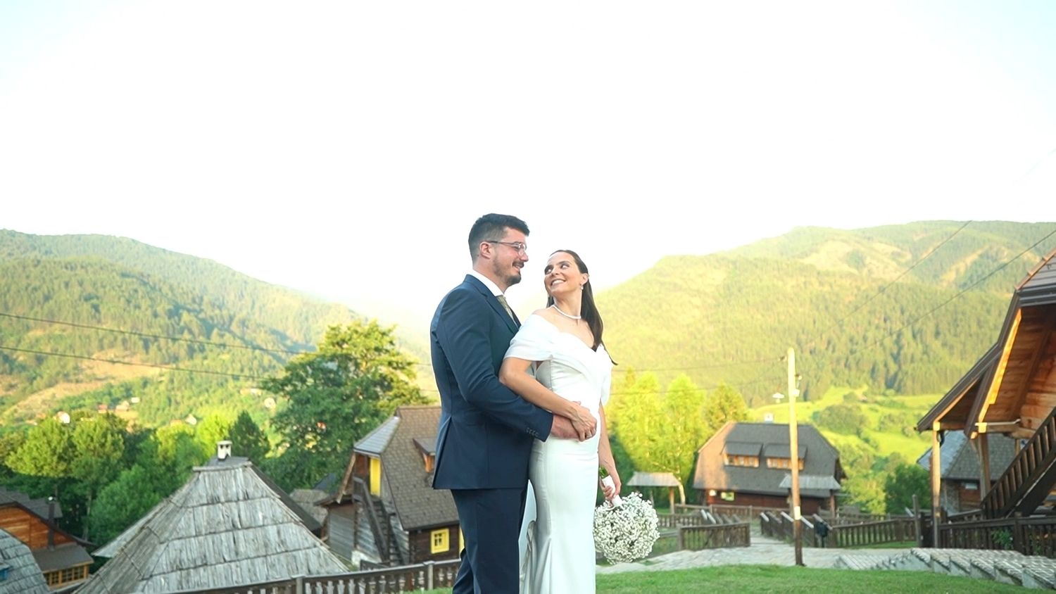 Scenic mountain wedding photos with couple against backdrop of rolling hills.