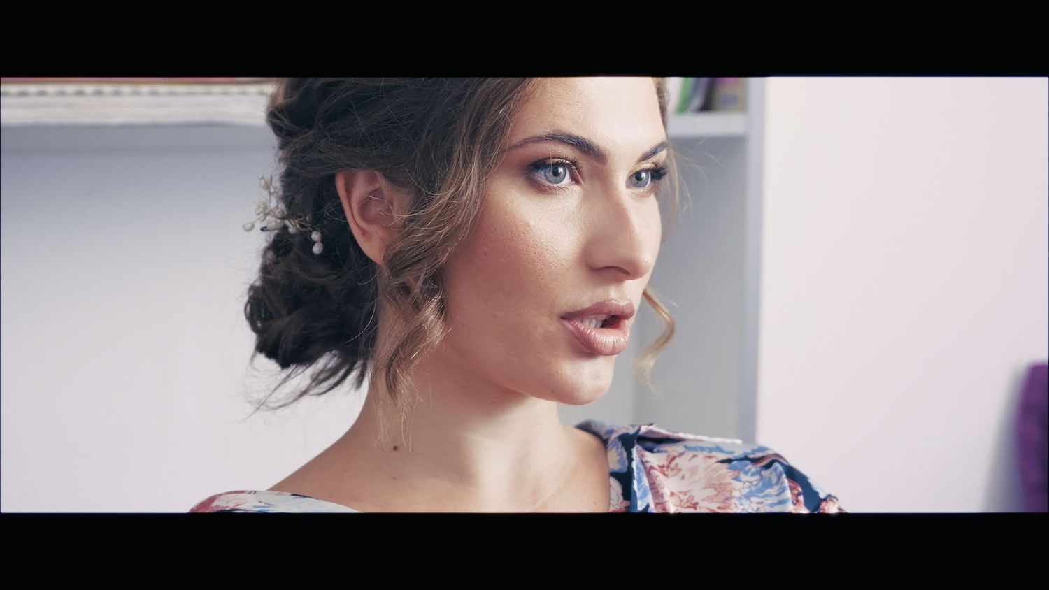 Side profile portrait with elegant updo hairstyle.