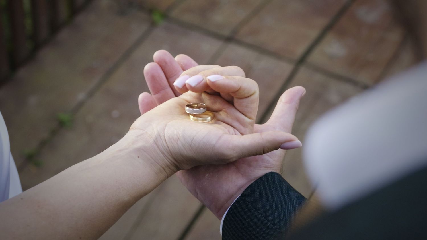 Close up of hands joined together in an emotional moment.