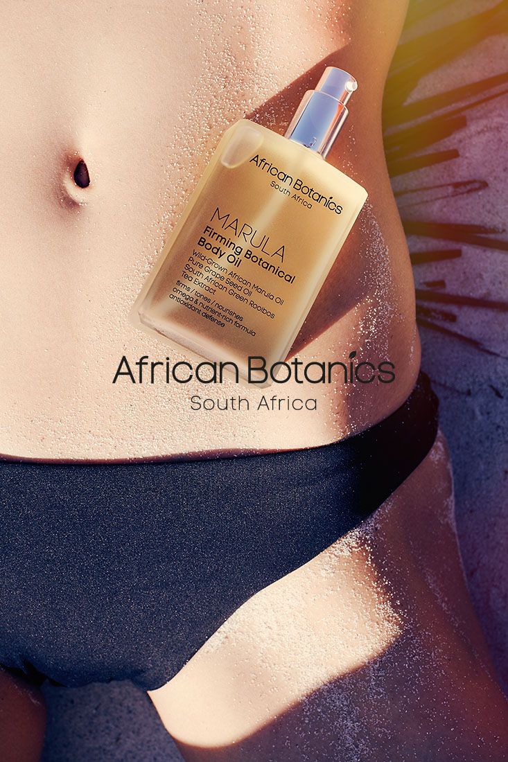Product shot of African Botanics skincare bottle against skin.