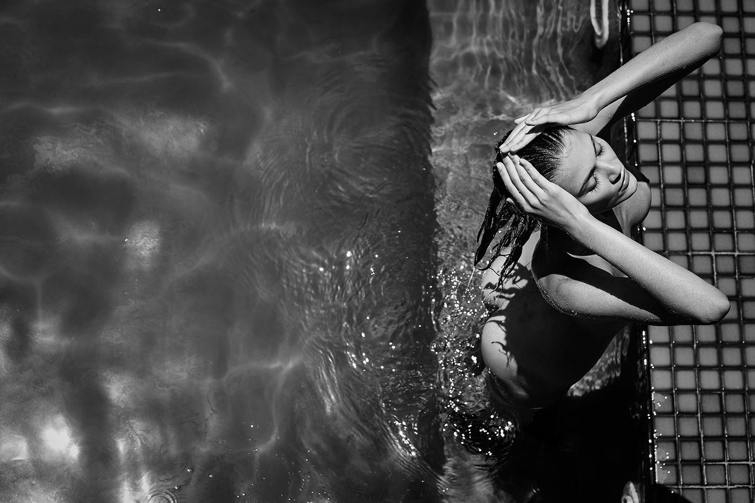 Black and white underwater photography with dramatic lighting and bubbles.