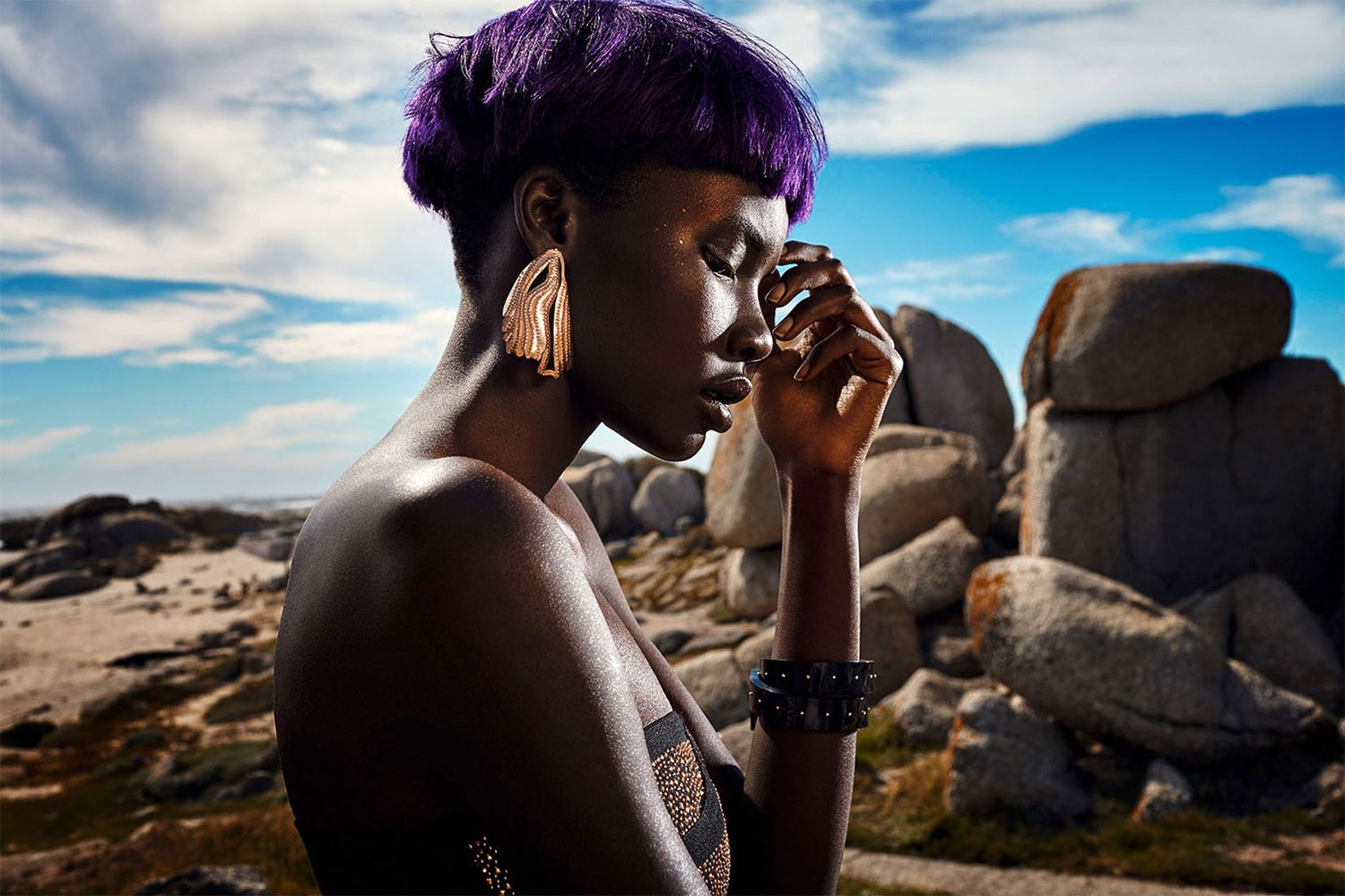 Artistic fashion photography series against rocky desert landscape with dramatic sky.