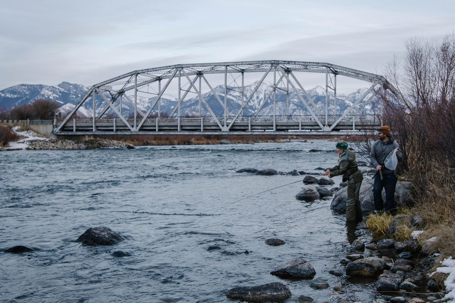A couple fly fishing on the Madison River