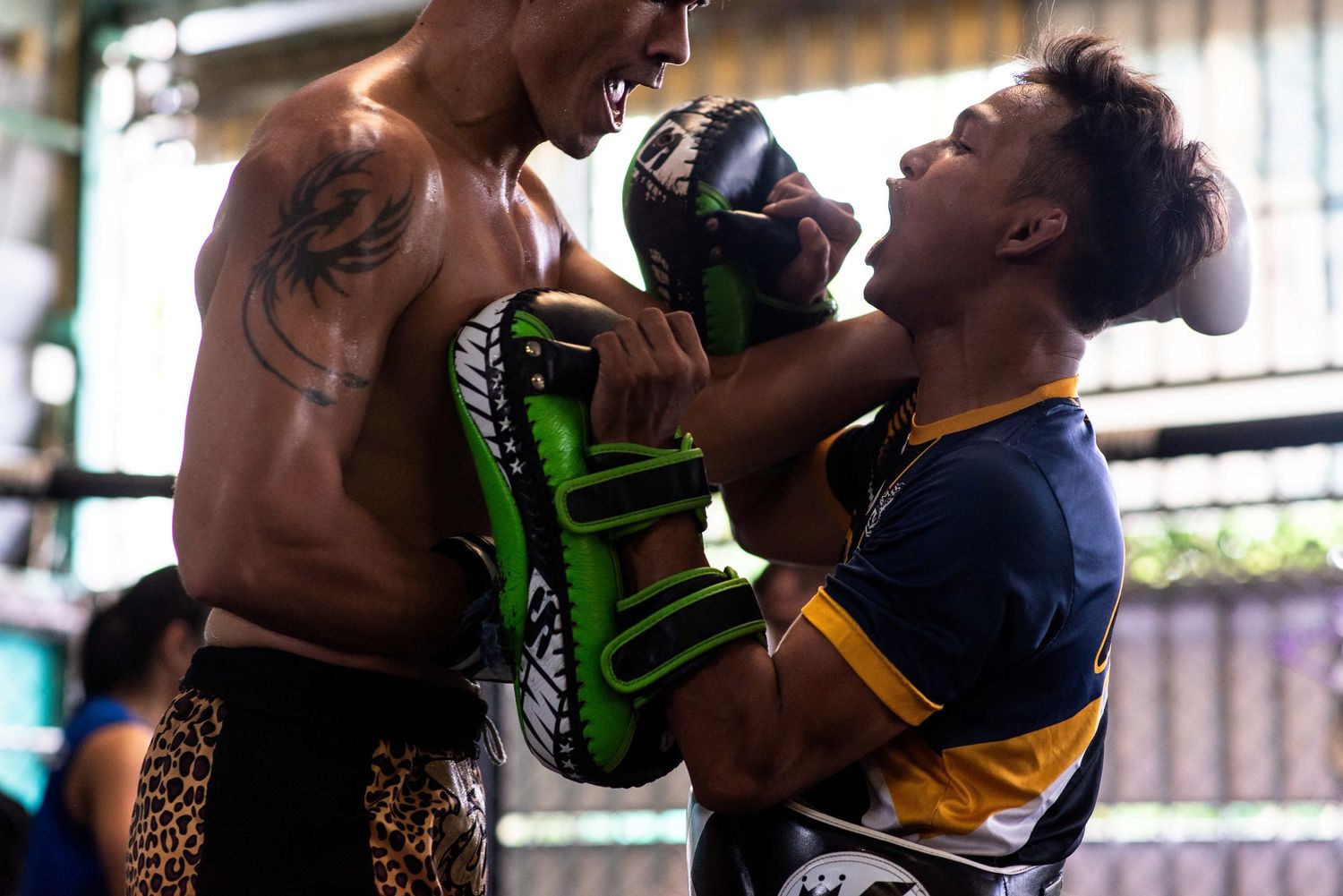 A Muay Thai fighter and his trainer at PK. Saenchai Muay Thai Gym, Bangkok, Thailand.