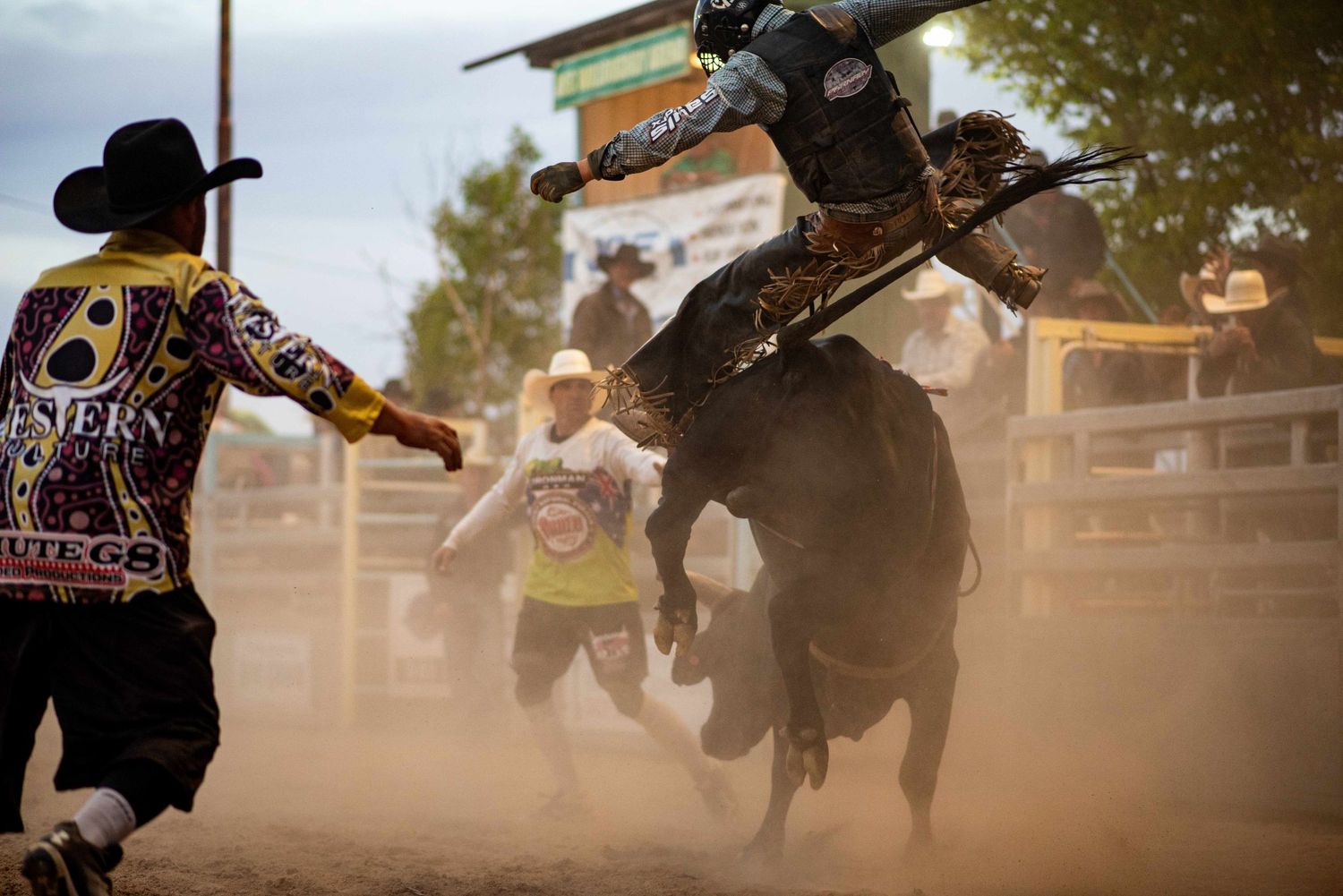 A young bull rider and a protection athlete at the Goulburn Bullarama, Reg Willoughby Arena, Goulburn, NSW, Australia.