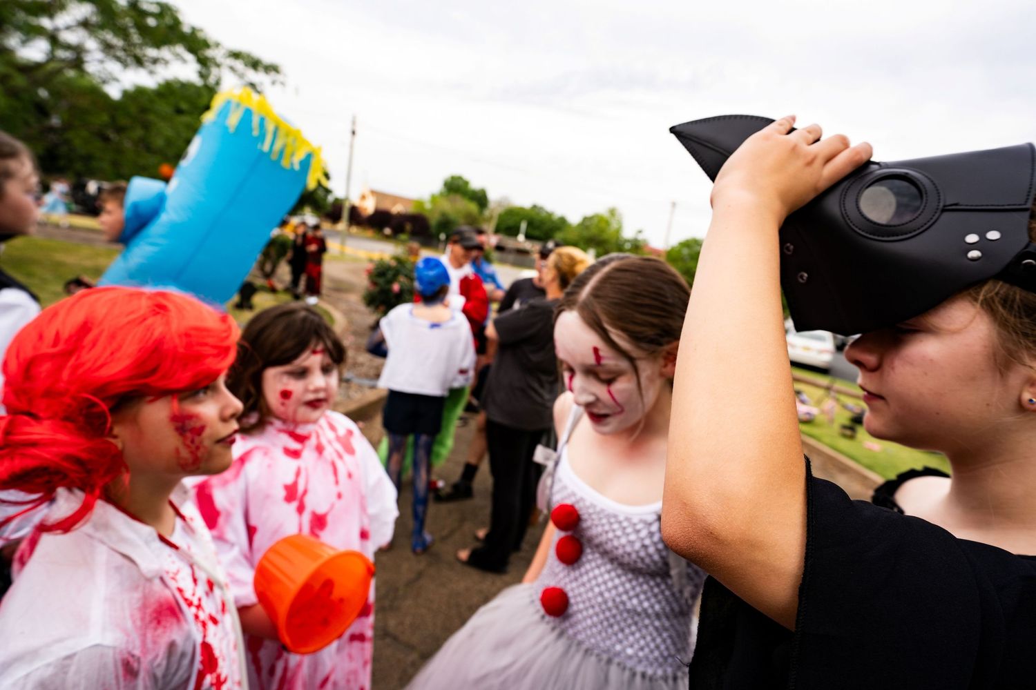 School kids gather in front of the old Cootamundra District Hospital in costume for Halloween.