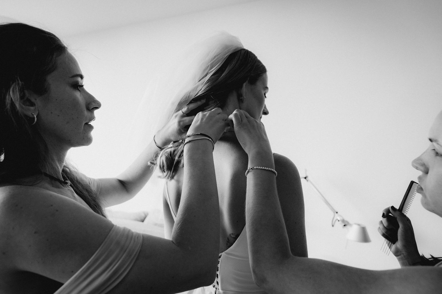 Black and white portrait series showing intimate emotional moments at a wedding.