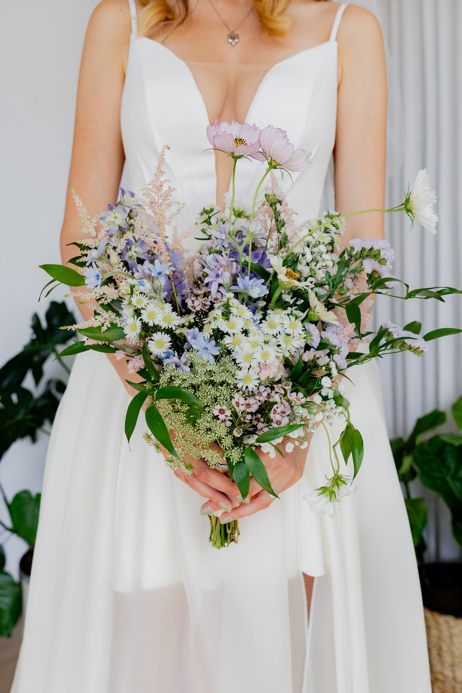 Elegant wedding bouquets featuring purple and white wildflowers and greenery.