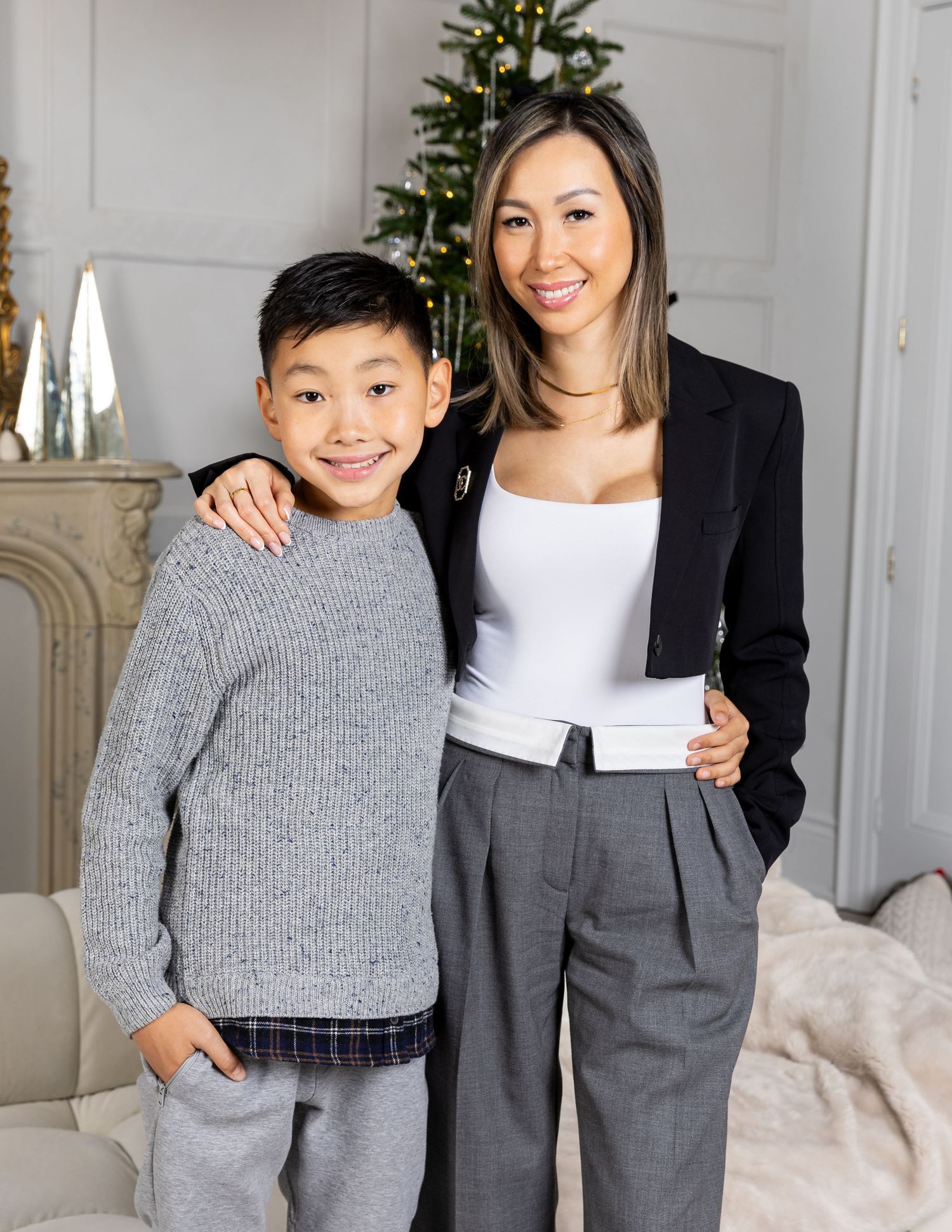 Indoor studio portraits with Christmas tree and elegant white decor.