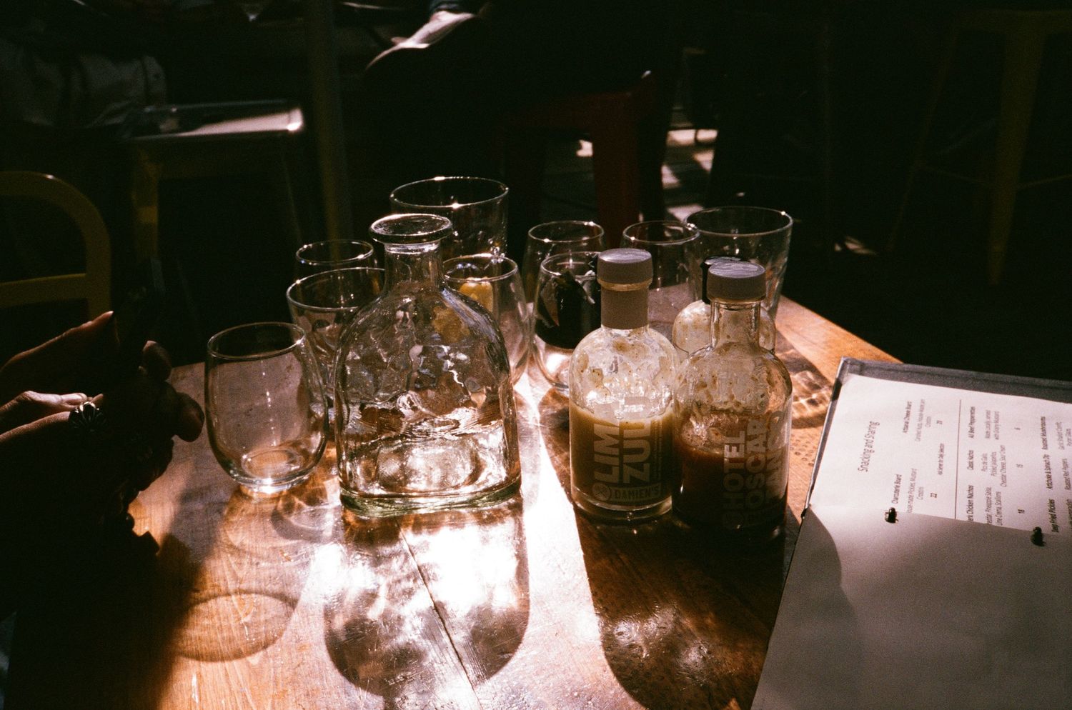 Dimly lit table setting with glass jars and candles creating ambient atmosphere.