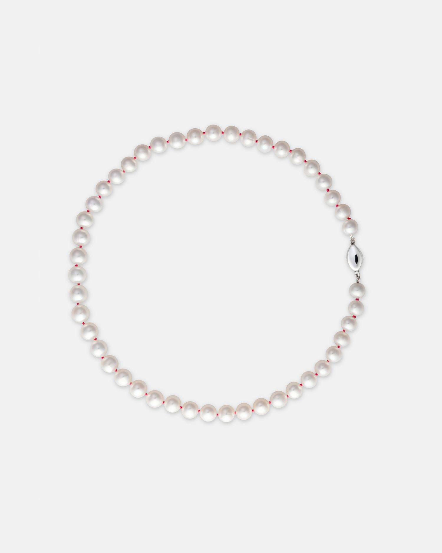 Pearl necklace displayed in circular formation on white background.