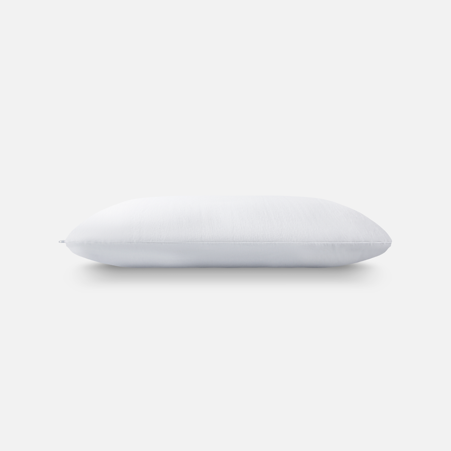 White pillow shown from different angles on light background.