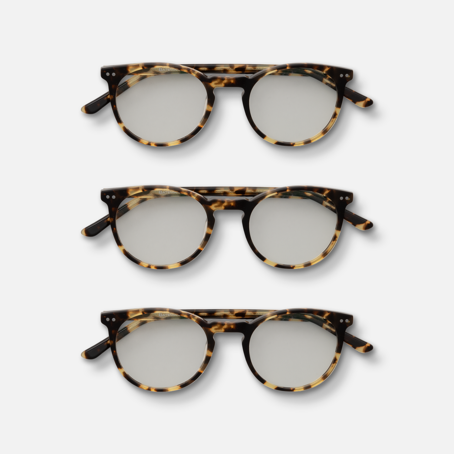 Three pairs of tortoiseshell pattern eyeglasses displayed in a row.