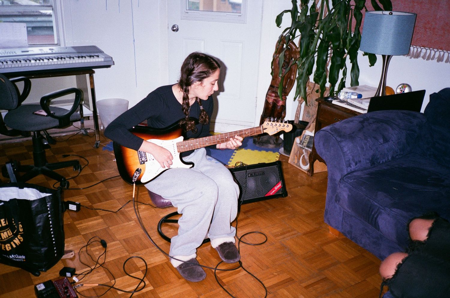 Indoor music studio setup with instruments and recording equipment.