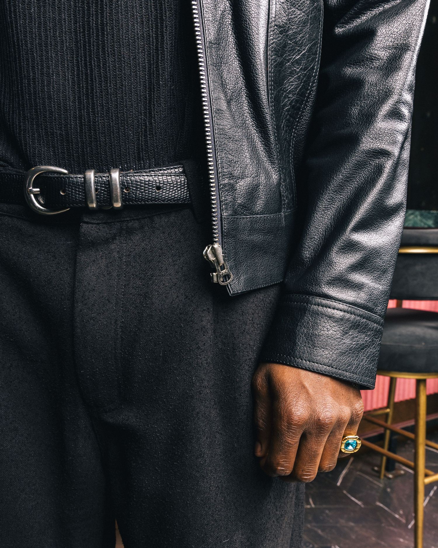 Detail shots of black leather jacket sleeves and cuffs.