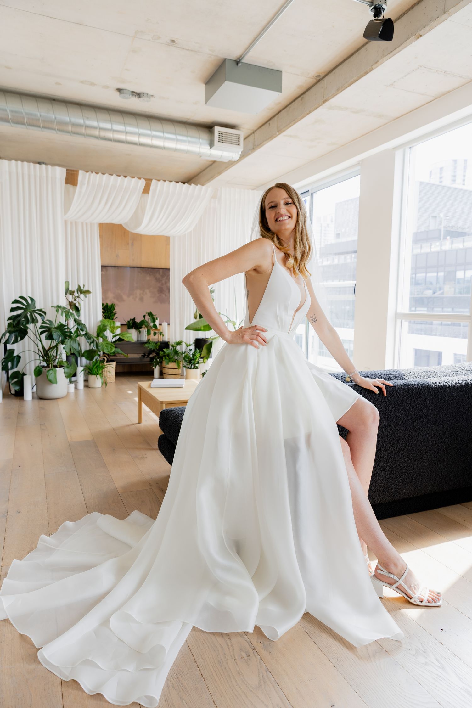 Series of photos showing flowing white dress movement in a bright modern space.