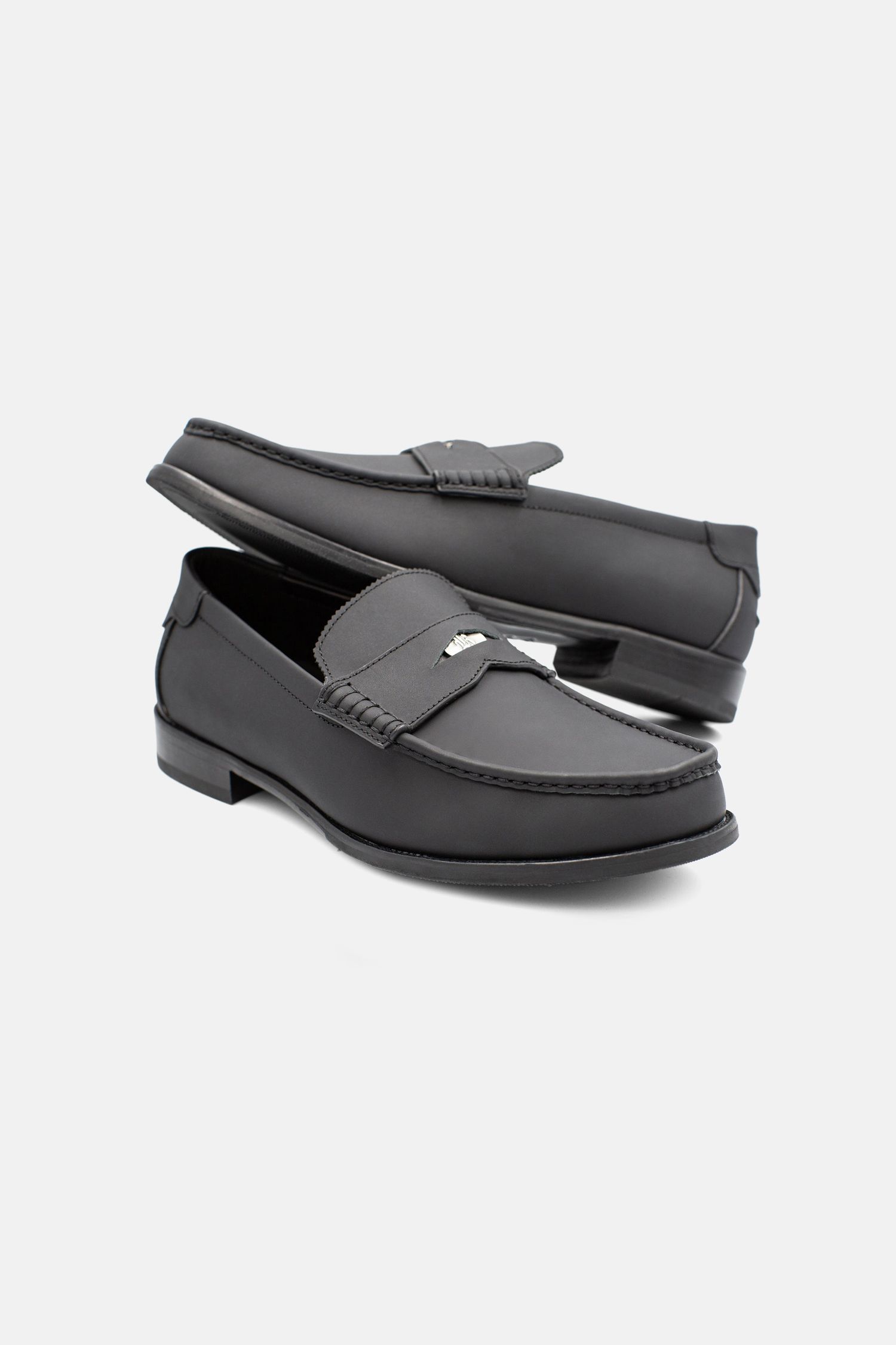 Classic black leather penny loafers with low heel.