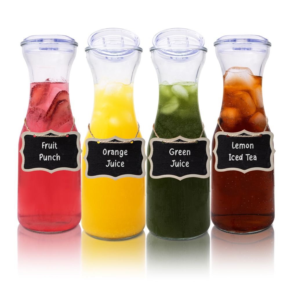 Collection of glass carafes filled with colorful beverages including fruit punch, juice, and iced tea.