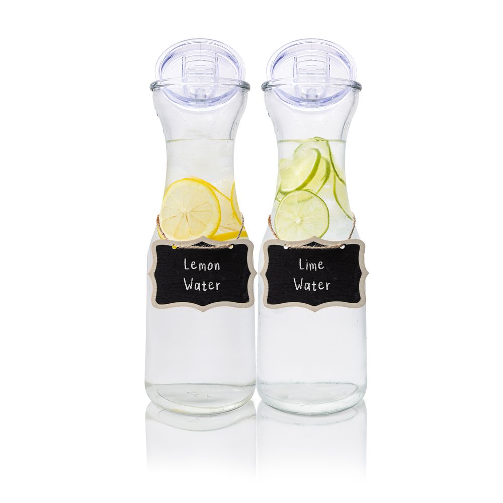 Clear glass carafes with lemon and lime slices labeled with chalkboard tags.