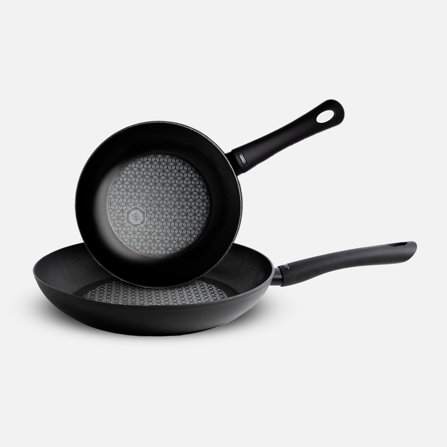 Black non-stick frying pan with honeycomb textured cooking surface.