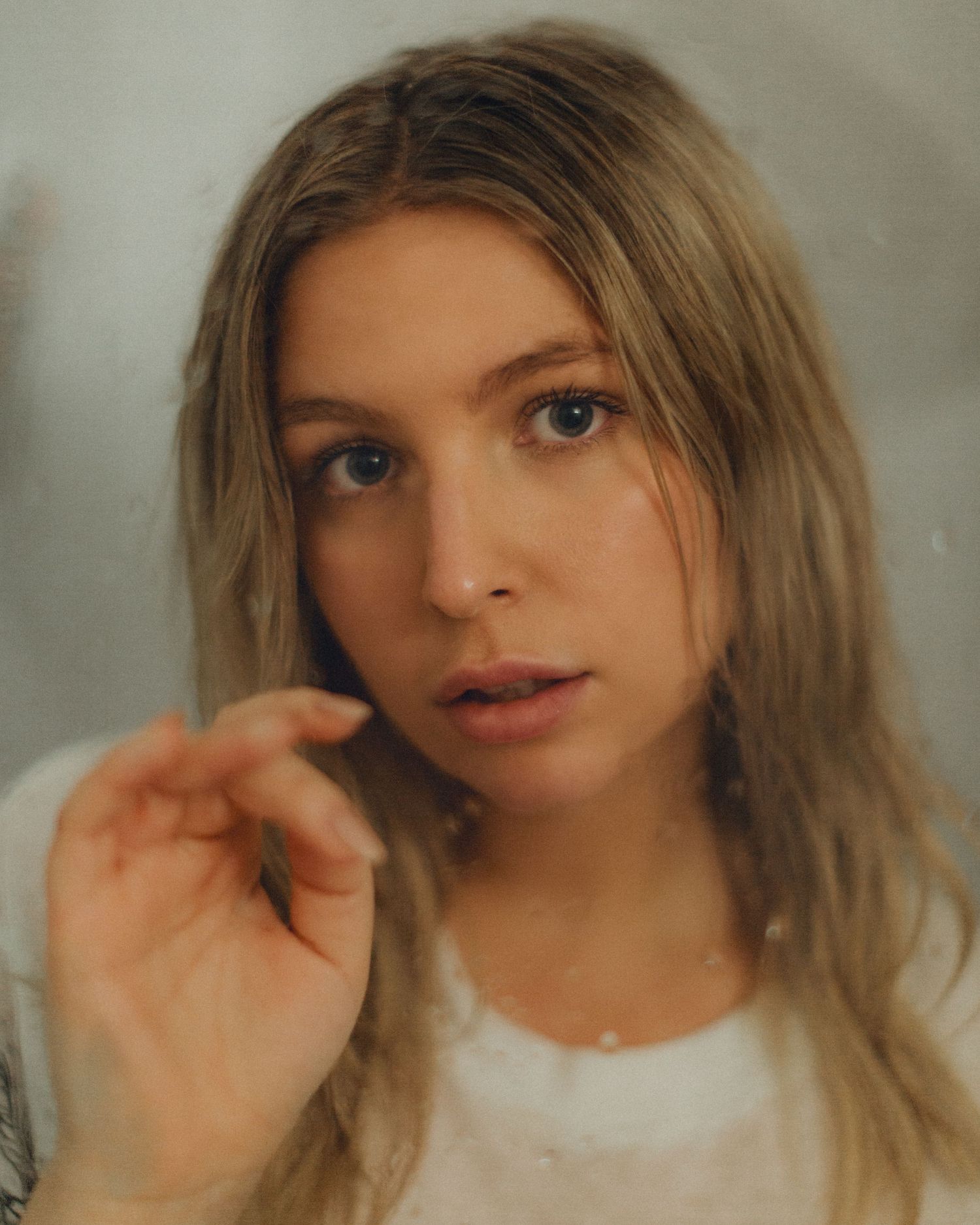 Soft focus portrait with dreamy lighting and natural makeup look.