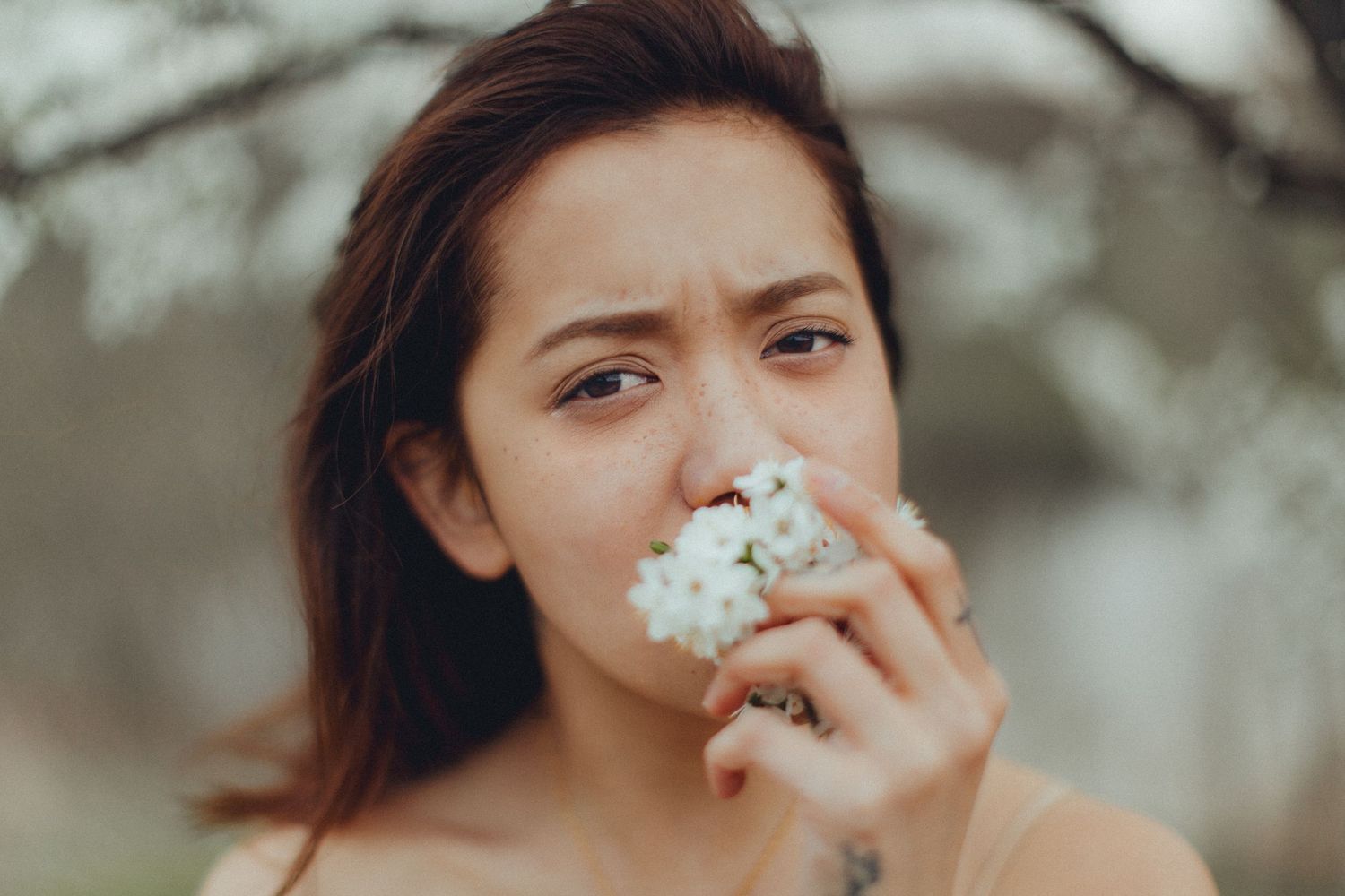 Soft focus portraits with delicate white flowers creating a romantic mood.