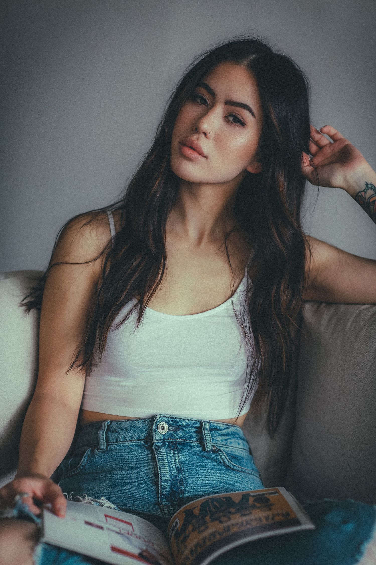 Fashion portrait series showing casual style with white tank top and denim.