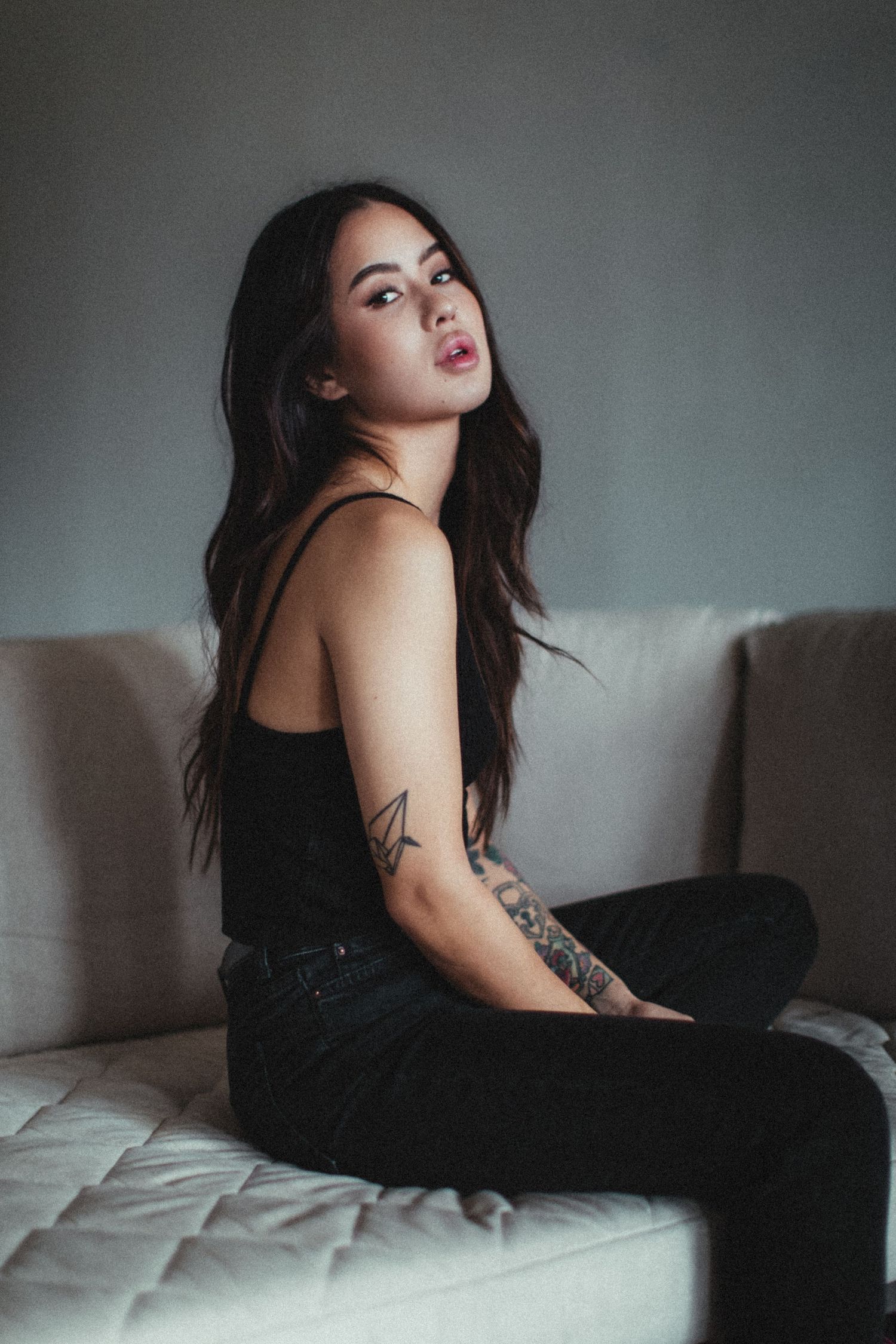 Intimate lifestyle photoshoot featuring black clothing against neutral background.