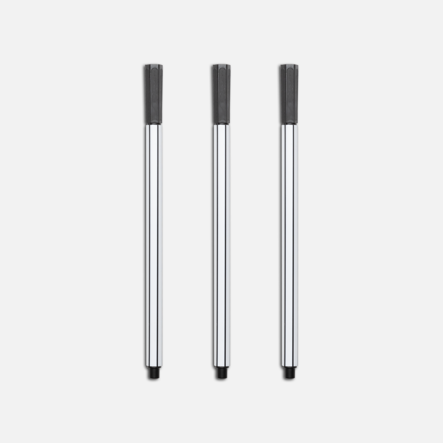 Three black marker pens arranged in a row on white background.