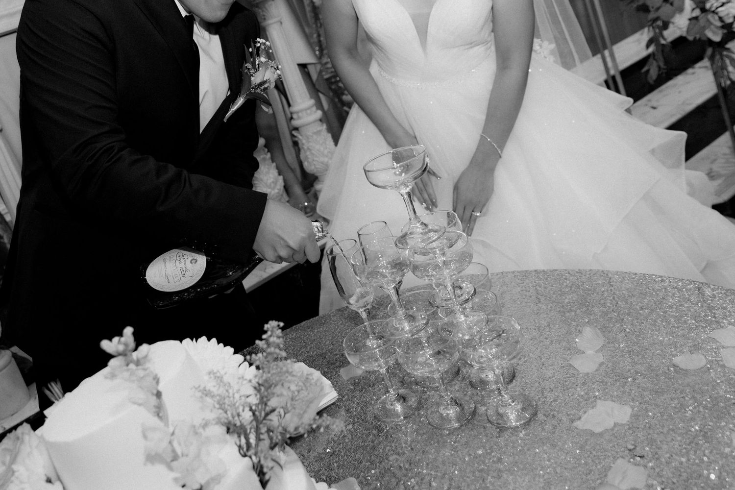 Row of champagne glasses being filled during a formal event.
