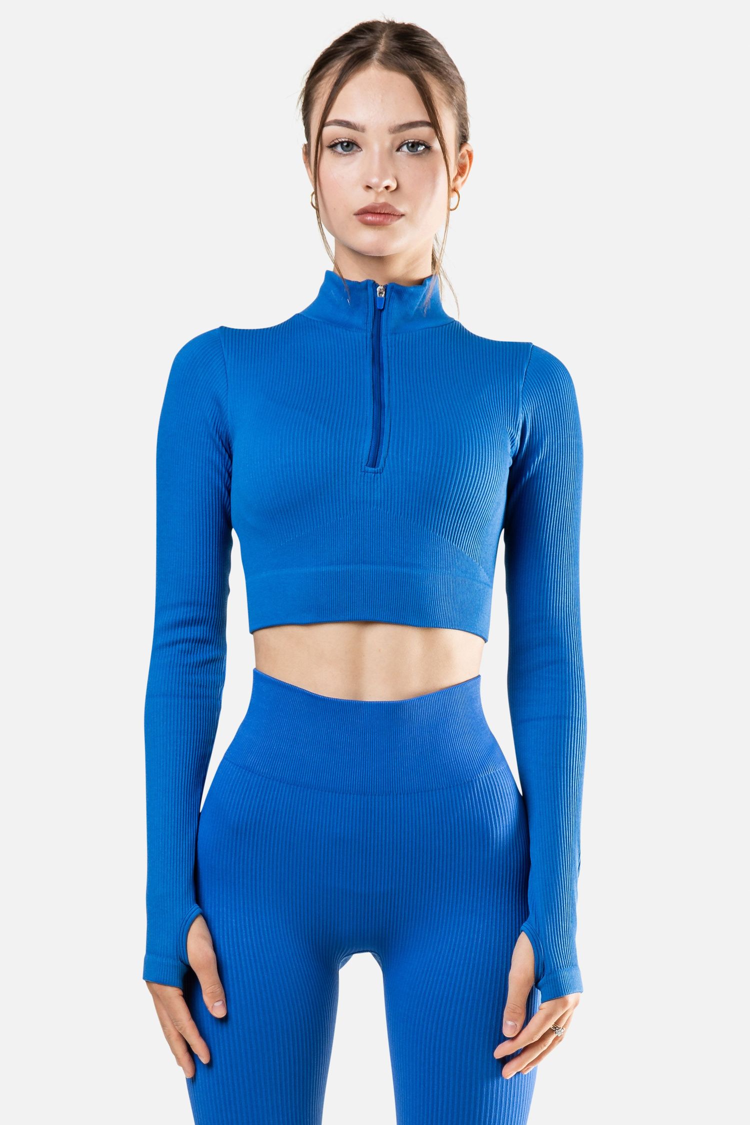 Bright blue ribbed workout set with quarter-zip crop top and high-waisted leggings.