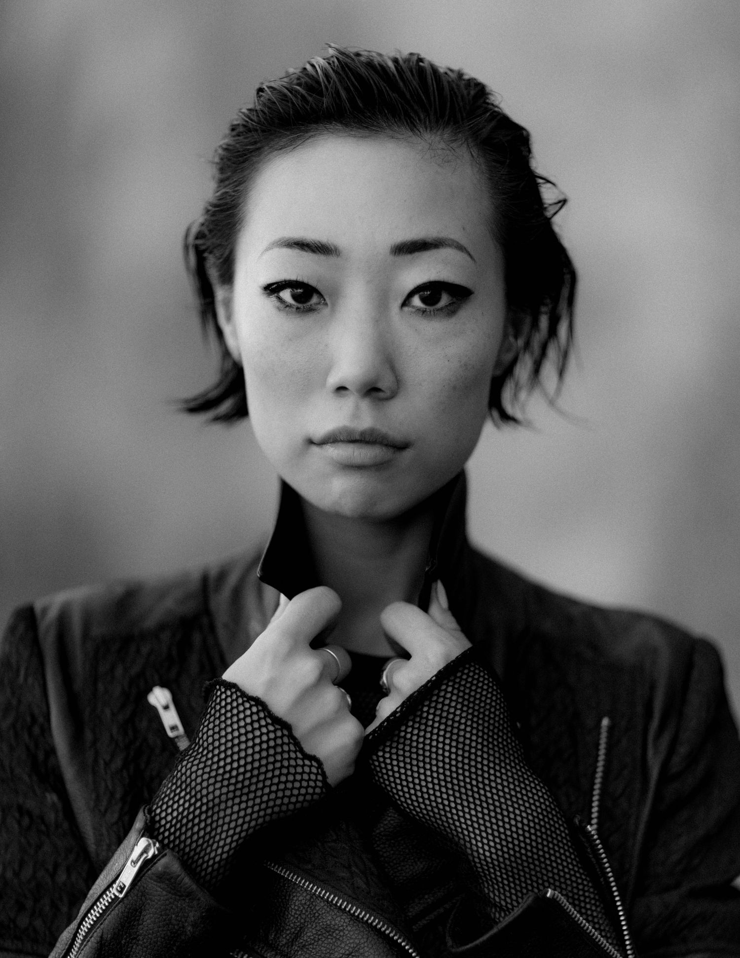 Black and white portrait series showing expressive poses in fingerless gloves.
