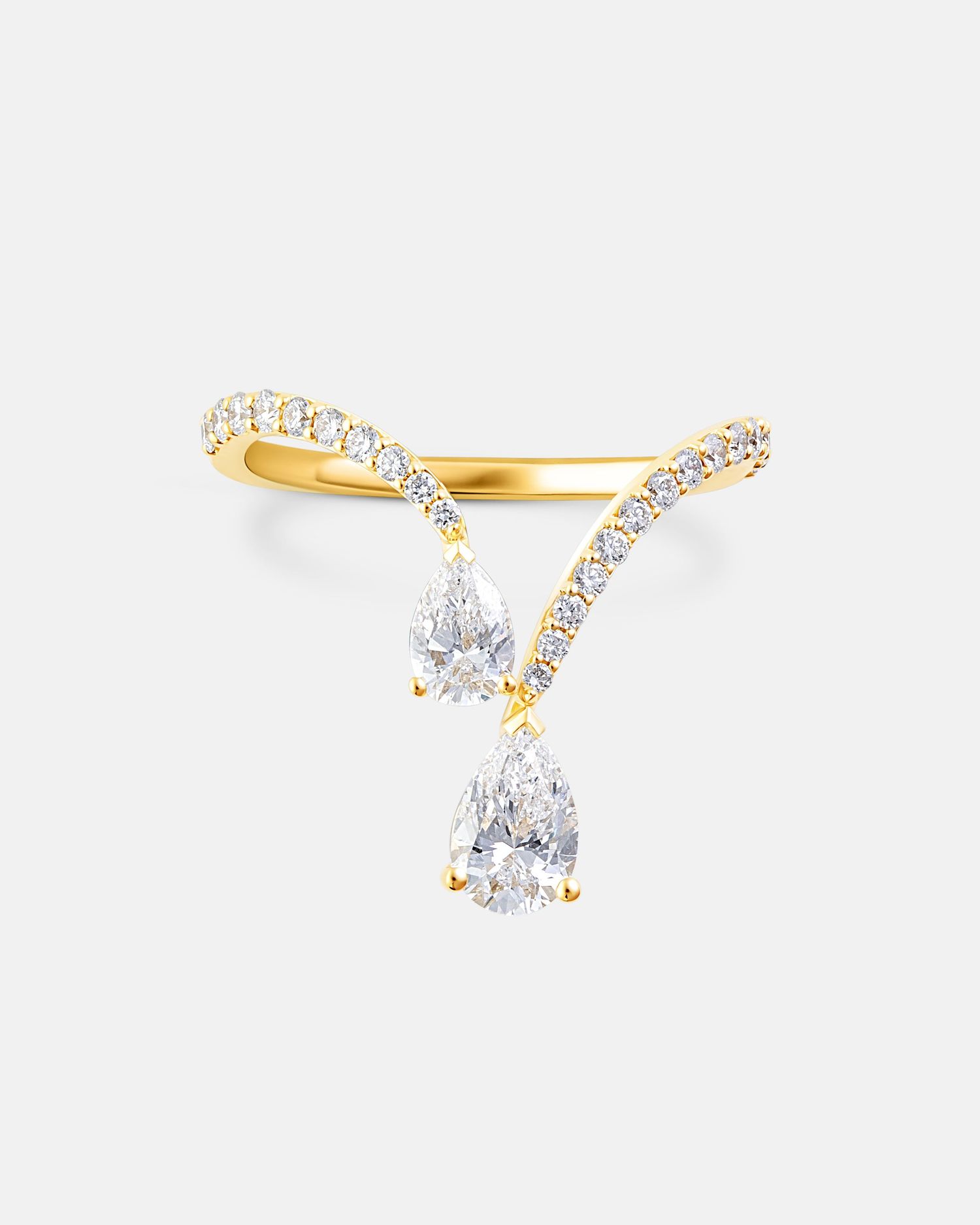 Dainty gold ring with pear-shaped crystal and pavé details.