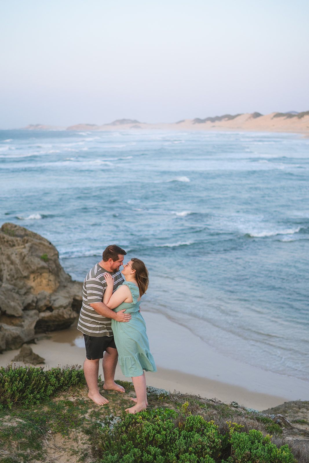 A couple on their engagement shoot at the beach photo taken by Jordie Captures