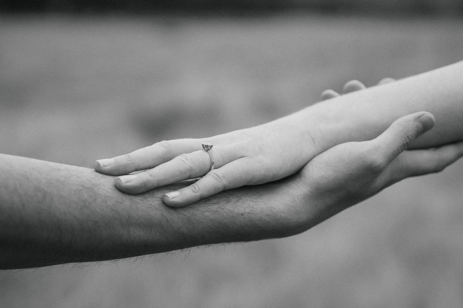 A couple on their engagement shoot in a forest, photo taken by Jordie Captures